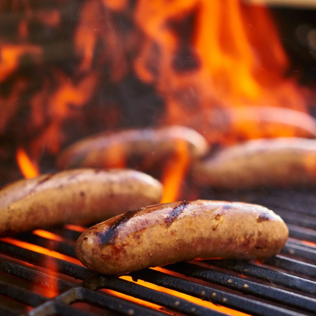 sausages being cooked on the grill